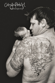 black and white portrait baby and daddy with tattoo